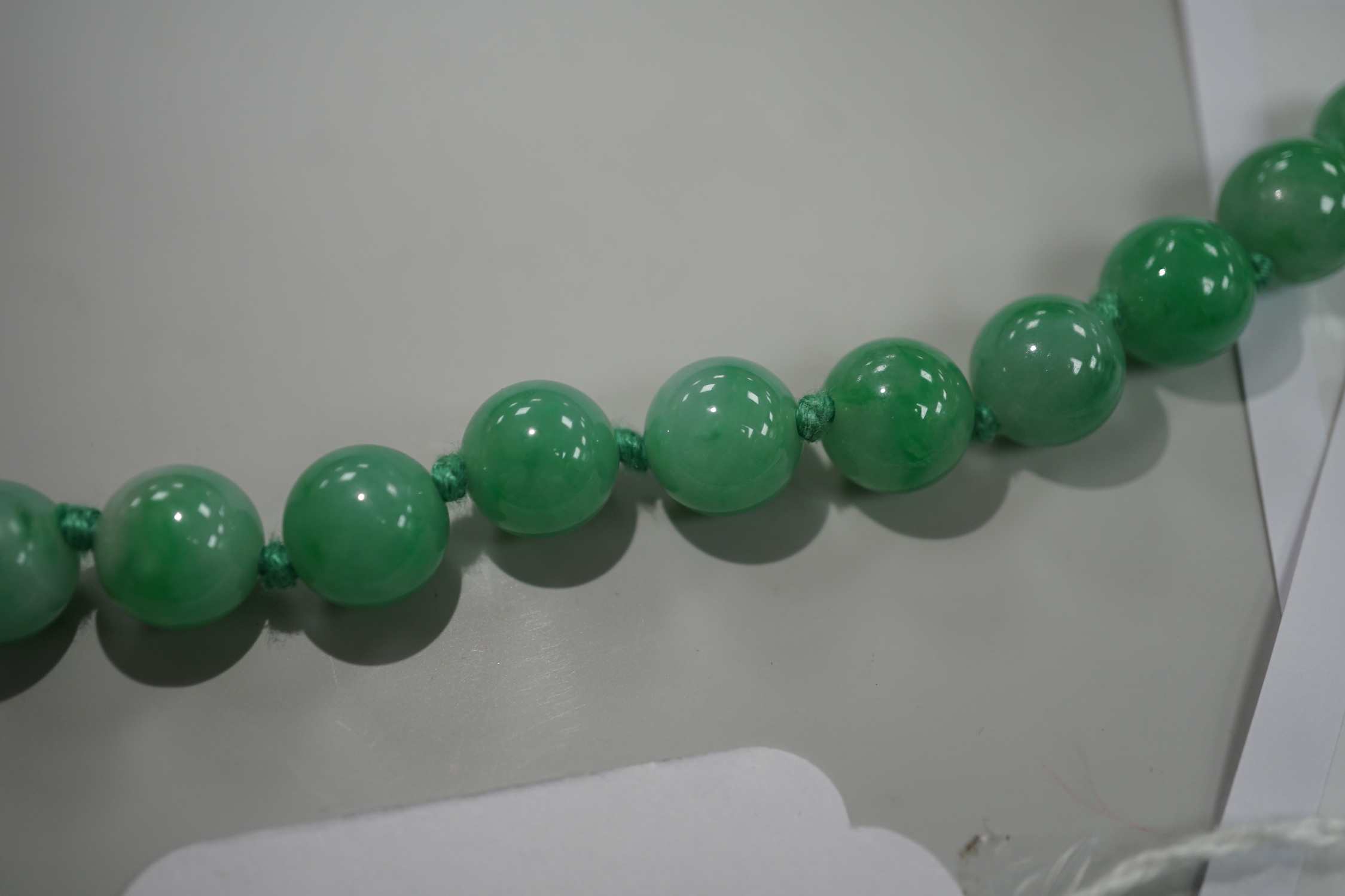 A single strand jade bead necklace, 58cm, gross weight 91 grams.